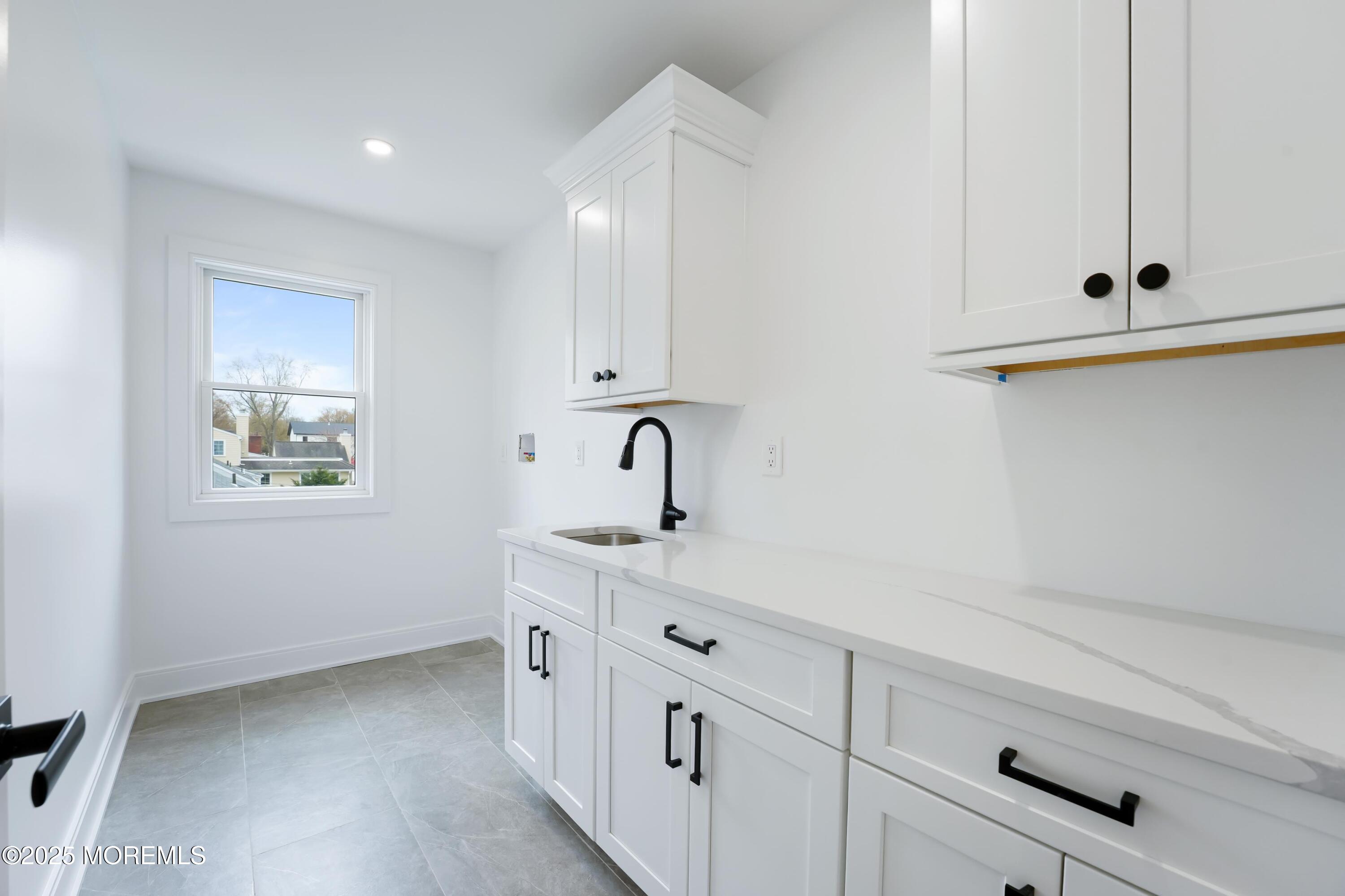 806 Arbor Road Paramus, NJ 07652 - Photo 21 of 29 a kitchen with white cabinets and sink