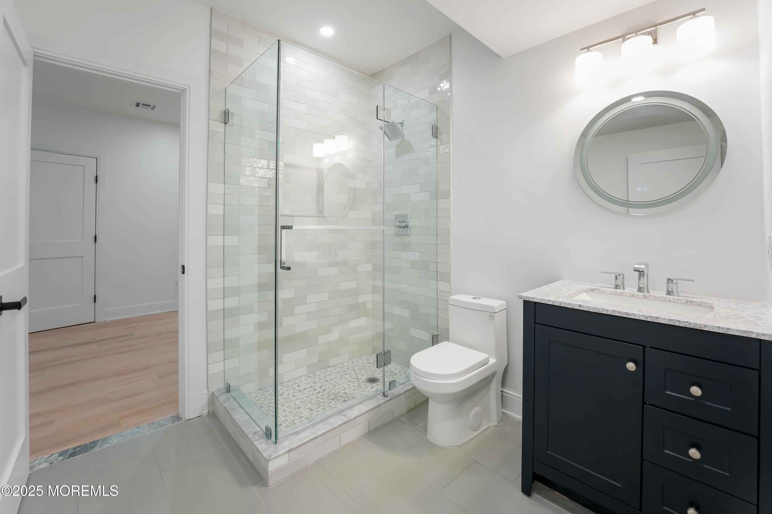 806 Arbor Road Paramus, NJ 07652 - Photo 23 of 29 a bathroom with a sink toilet a mirror and shower