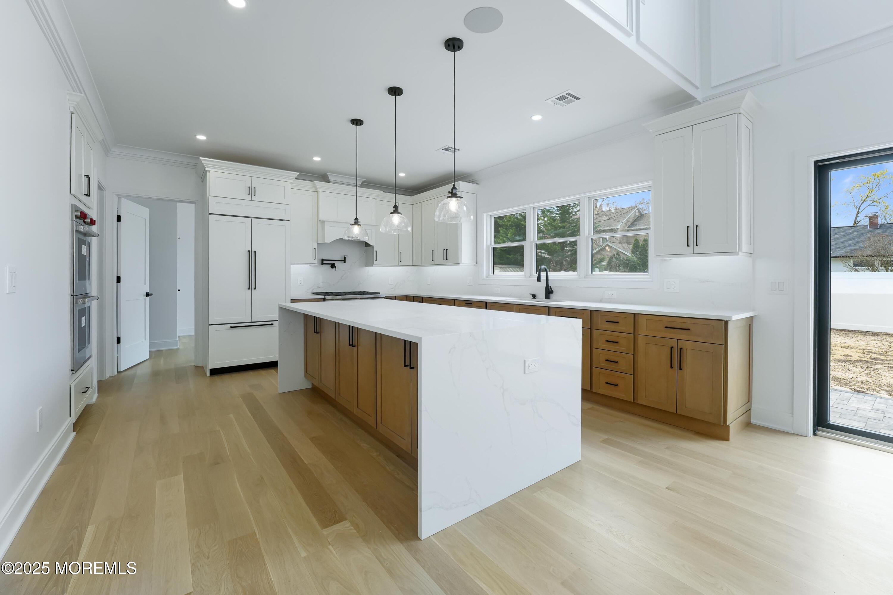 806 Arbor Road Paramus, NJ 07652 - Photo 6 of 29 a kitchen with a sink a counter top space stainless steel appliances and a window