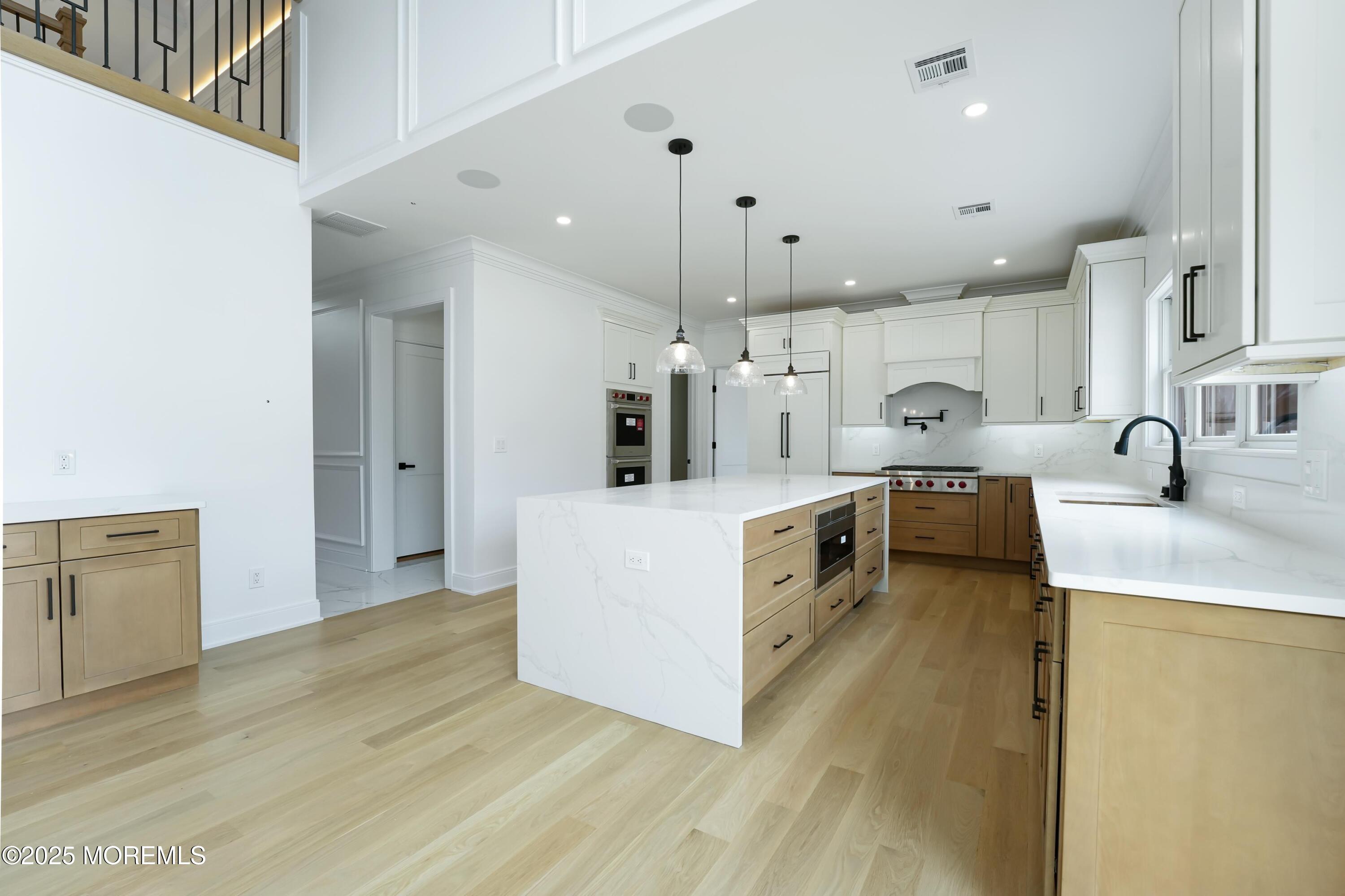 806 Arbor Road Paramus, NJ 07652 - Photo 7 of 29 a kitchen with stainless steel appliances a sink a stove top oven a counter space and cabinets