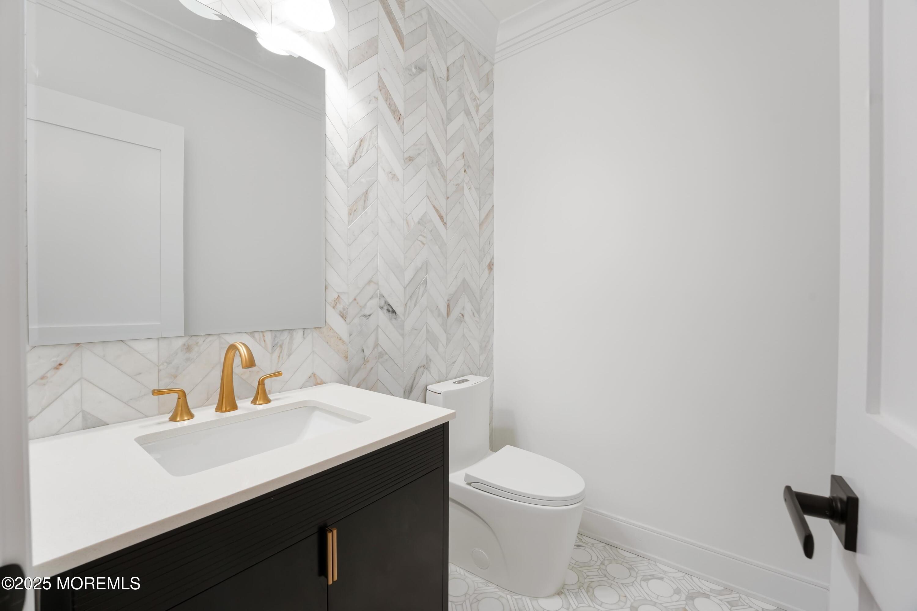 806 Arbor Road Paramus, NJ 07652 - Photo 9 of 29 a bathroom with a sink a toilet and vanity