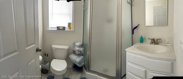 a white toilet sitting next to a bathroom sink