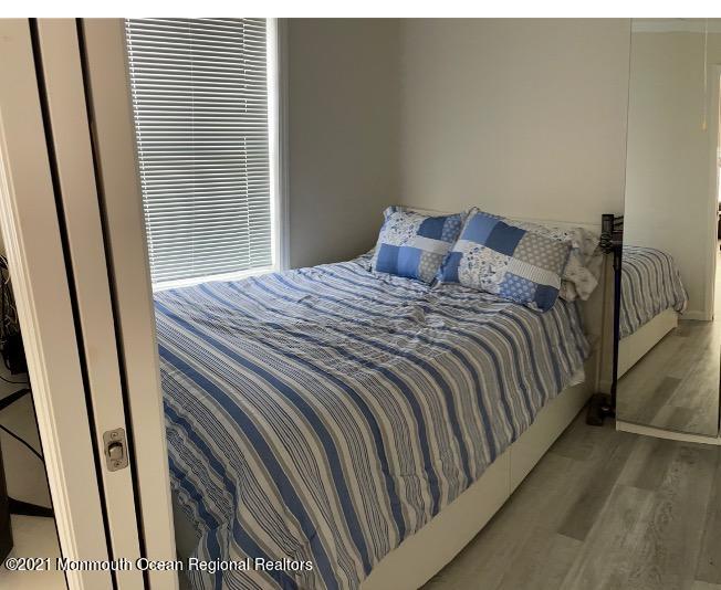 121 West Tide Way Lavallette, NJ 08735 - Photo 5 of 20 a bedroom with a bed and wooden floor