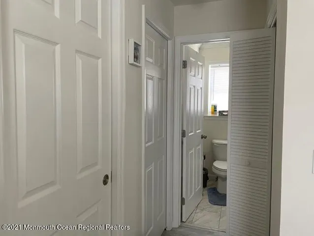 a bathroom with a granite countertop toilet and a shower