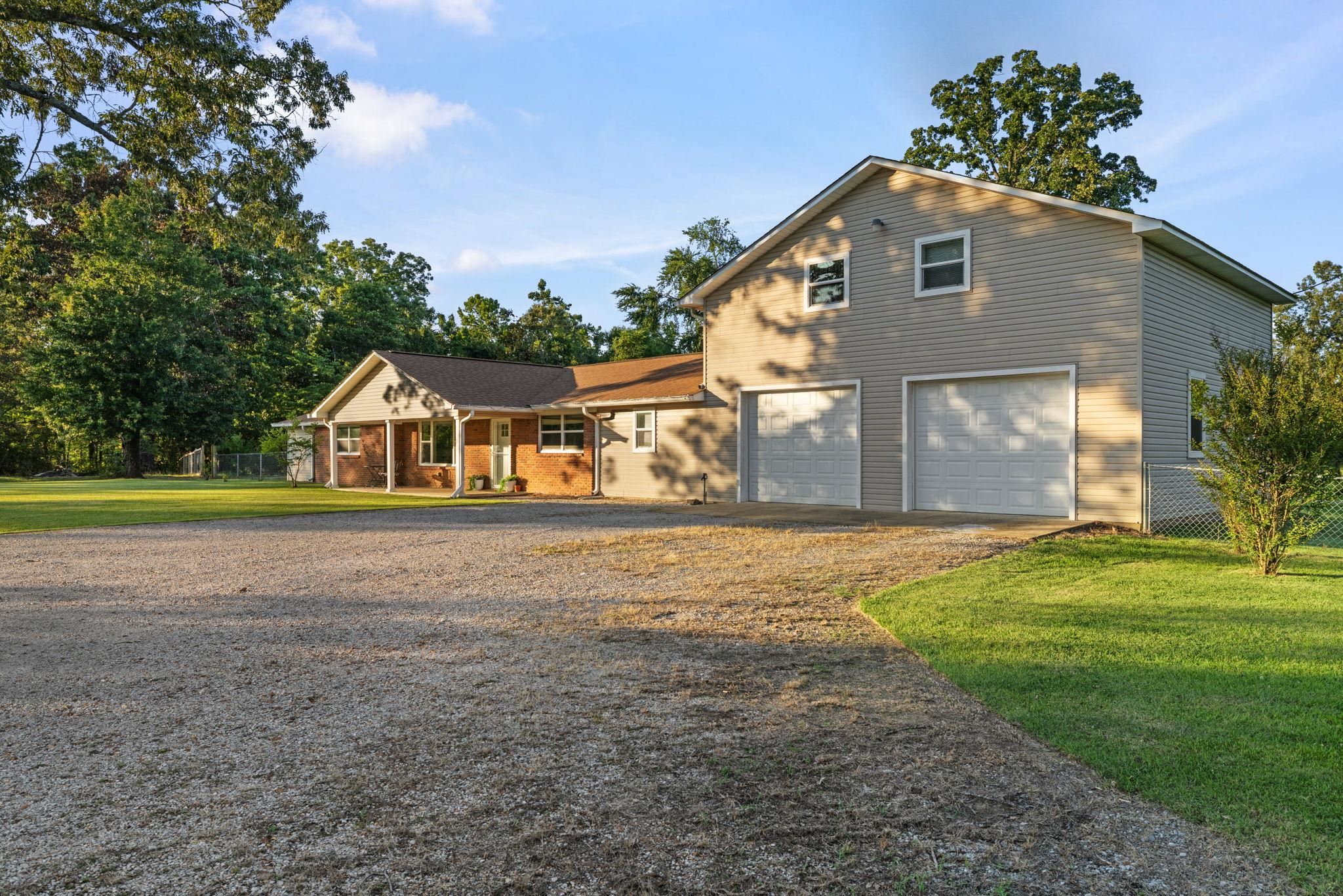 66 County Road 511 Corinth, MS 38834 - Photo 3 of 40 Exterior featuring a two-story attached garage with two overhead doors