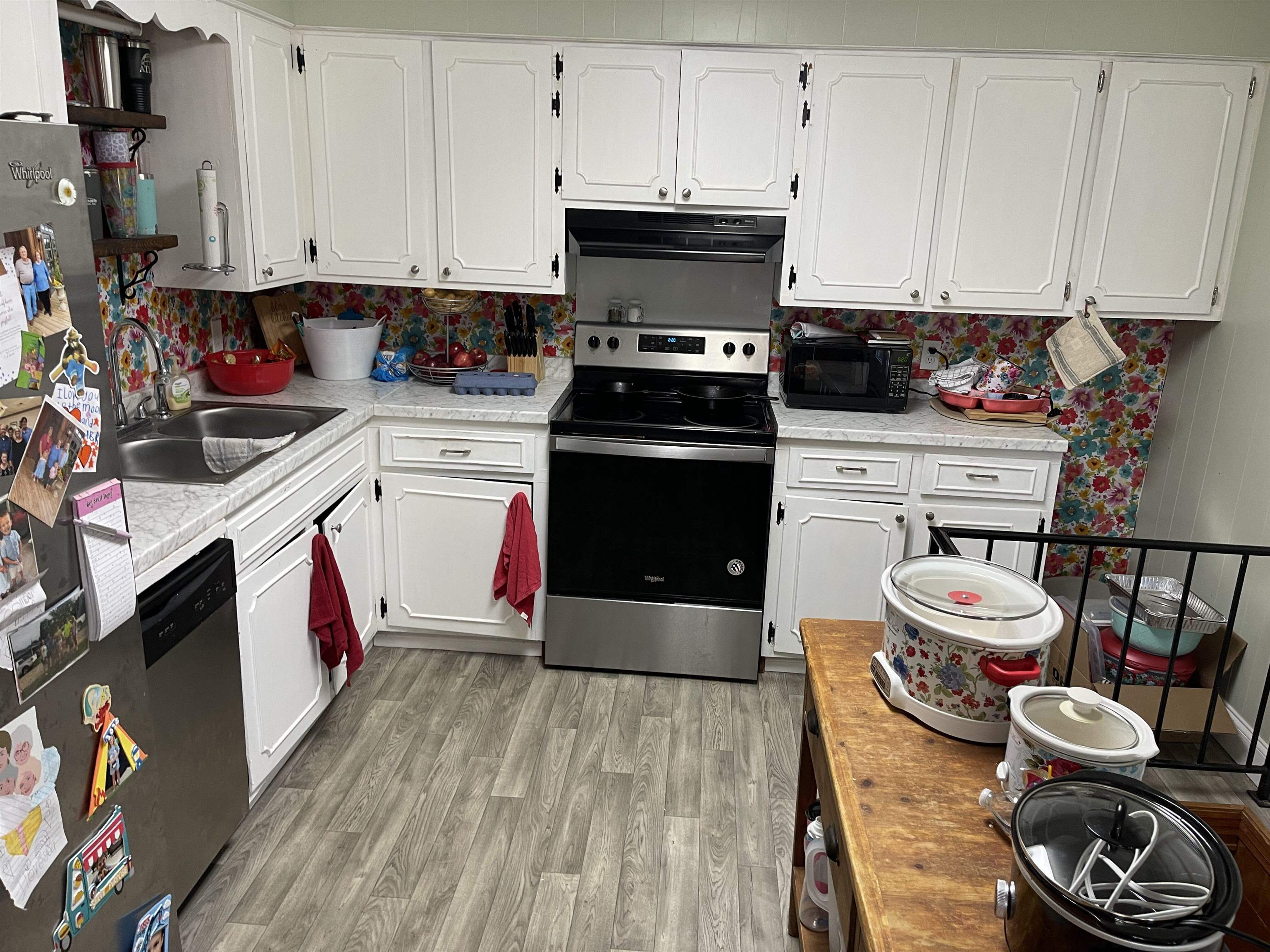 81 Puron Road Adamsville, TN 38310 - Photo 13 of 40 a kitchen with stainless steel appliances kitchen island granite countertop a stove a sink and white cabinets