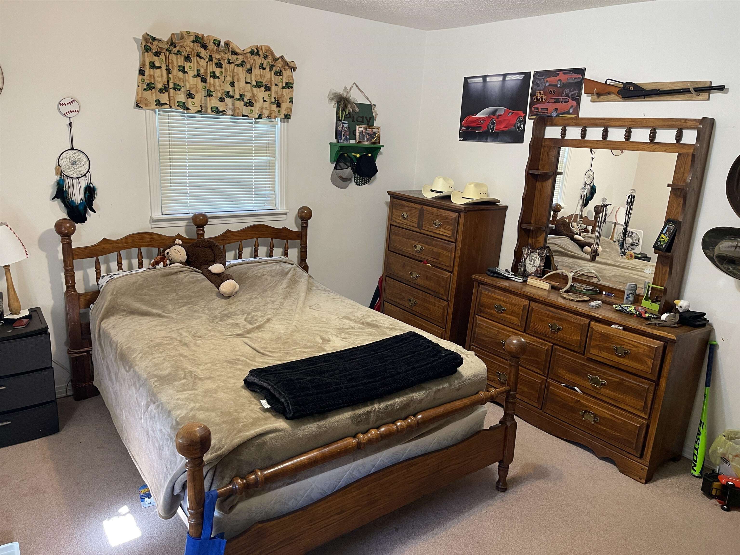 81 Puron Road Adamsville, TN 38310 - Photo 18 of 40 a bed sitting in a bedroom next to a window