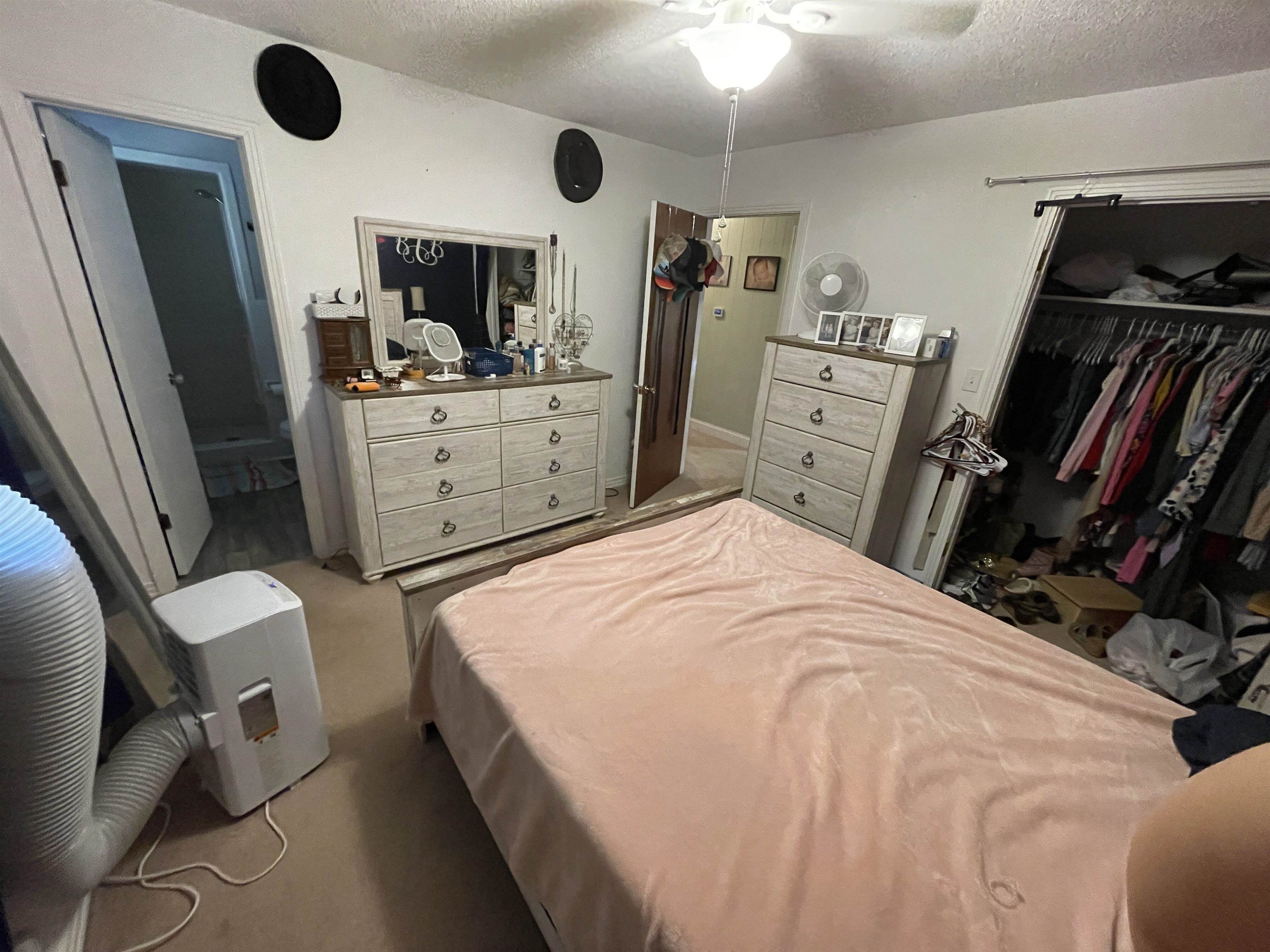 81 Puron Road Adamsville, TN 38310 - Photo 23 of 40 a bedroom with a bed and a flat tv screen on dresser