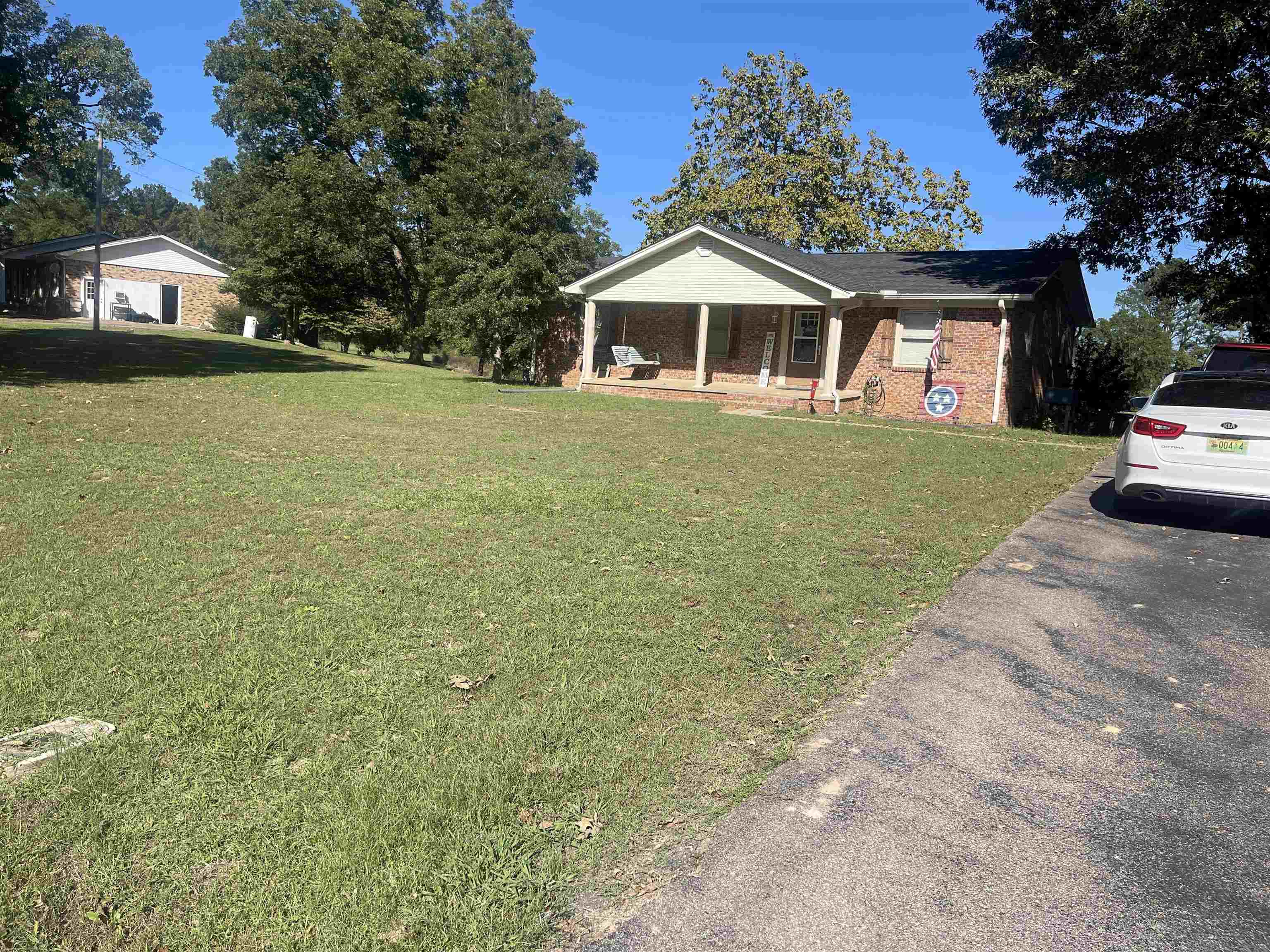81 Puron Road Adamsville, TN 38310 - Photo 3 of 40 a front view of a house with a garden