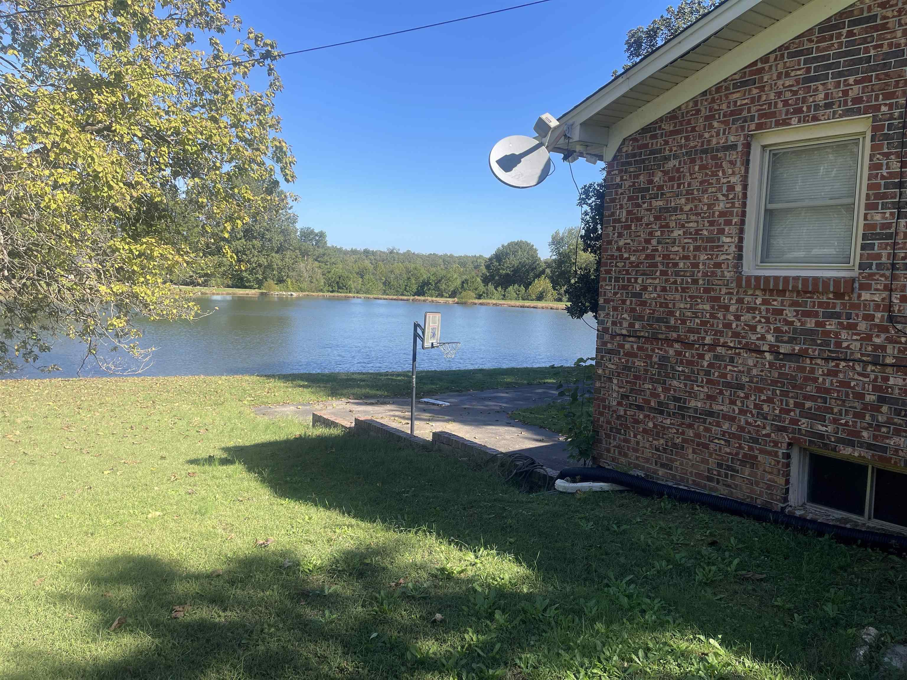 81 Puron Road Adamsville, TN 38310 - Photo 37 of 40 a view of a lake from a yard