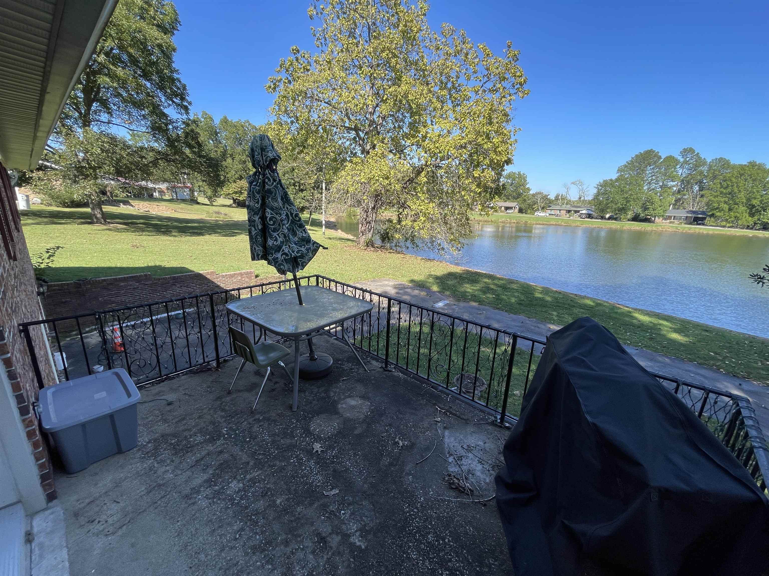 81 Puron Road Adamsville, TN 38310 - Photo 4 of 40 a view of a lake with a table and chairs