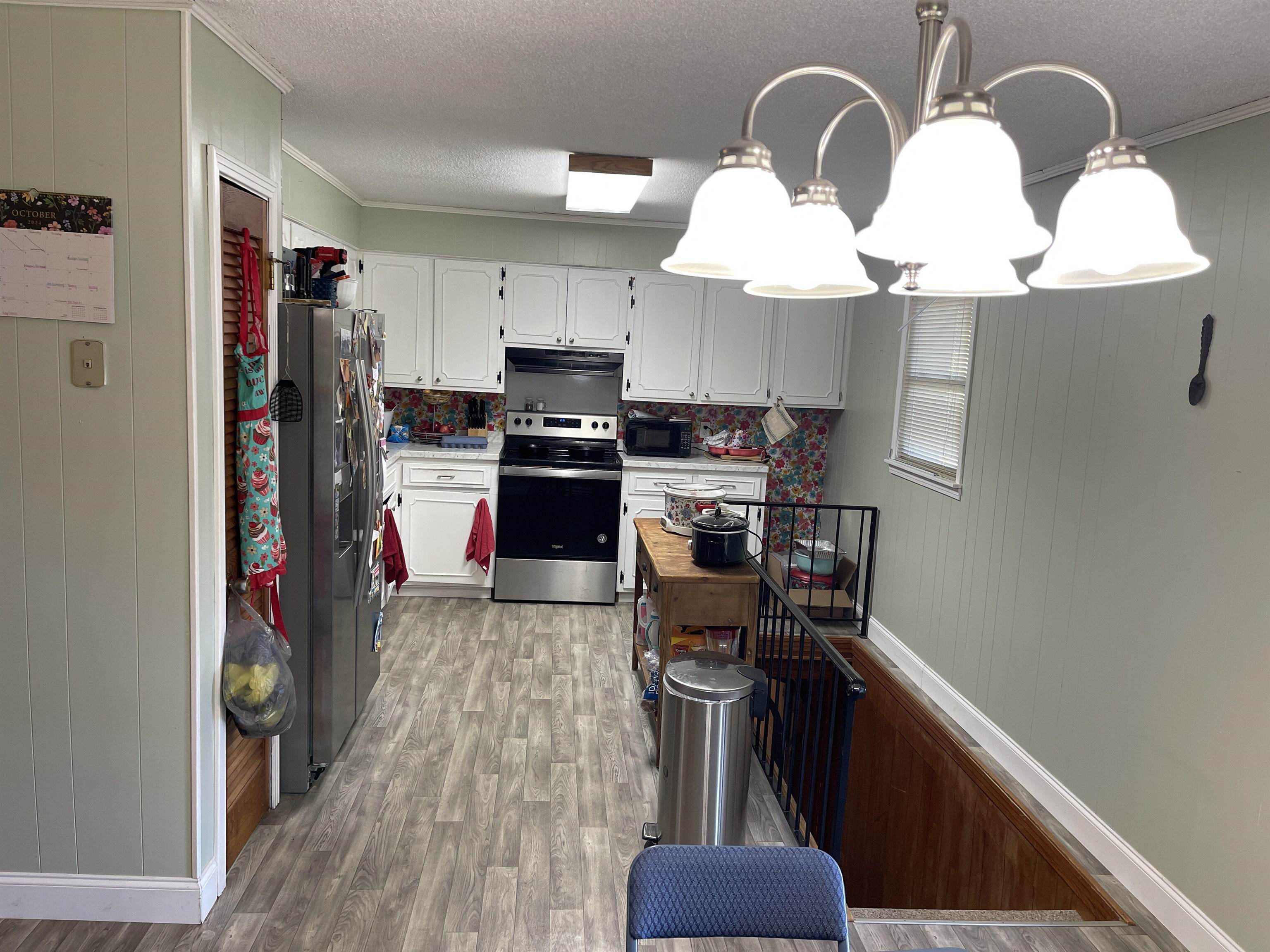 81 Puron Road Adamsville, TN 38310 - Photo 8 of 40 a kitchen with stainless steel appliances granite countertop a refrigerator a stove a sink dishwasher and a microwave oven