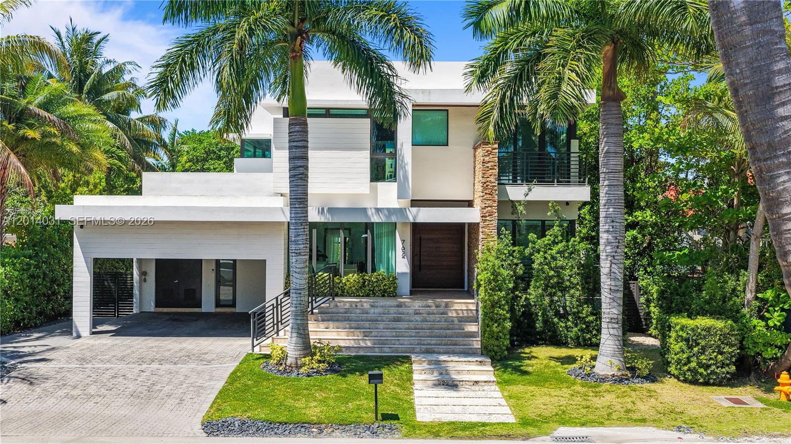762 Fernwood Road Key Biscayne, FL 33149 - Photo 3 of 82 a front view of house with yard and green space