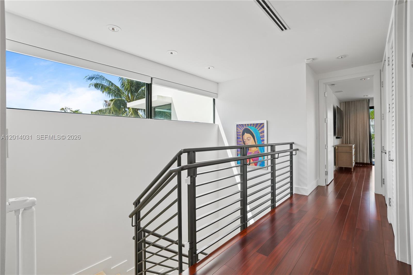 762 Fernwood Road Key Biscayne, FL 33149 - Photo 41 of 82 a view of a hallway with wooden floor and stairs