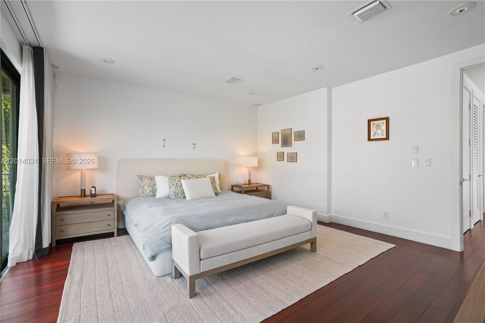 762 Fernwood Road Key Biscayne, FL 33149 - Photo 44 of 82 a bedroom with a bed and a night stand