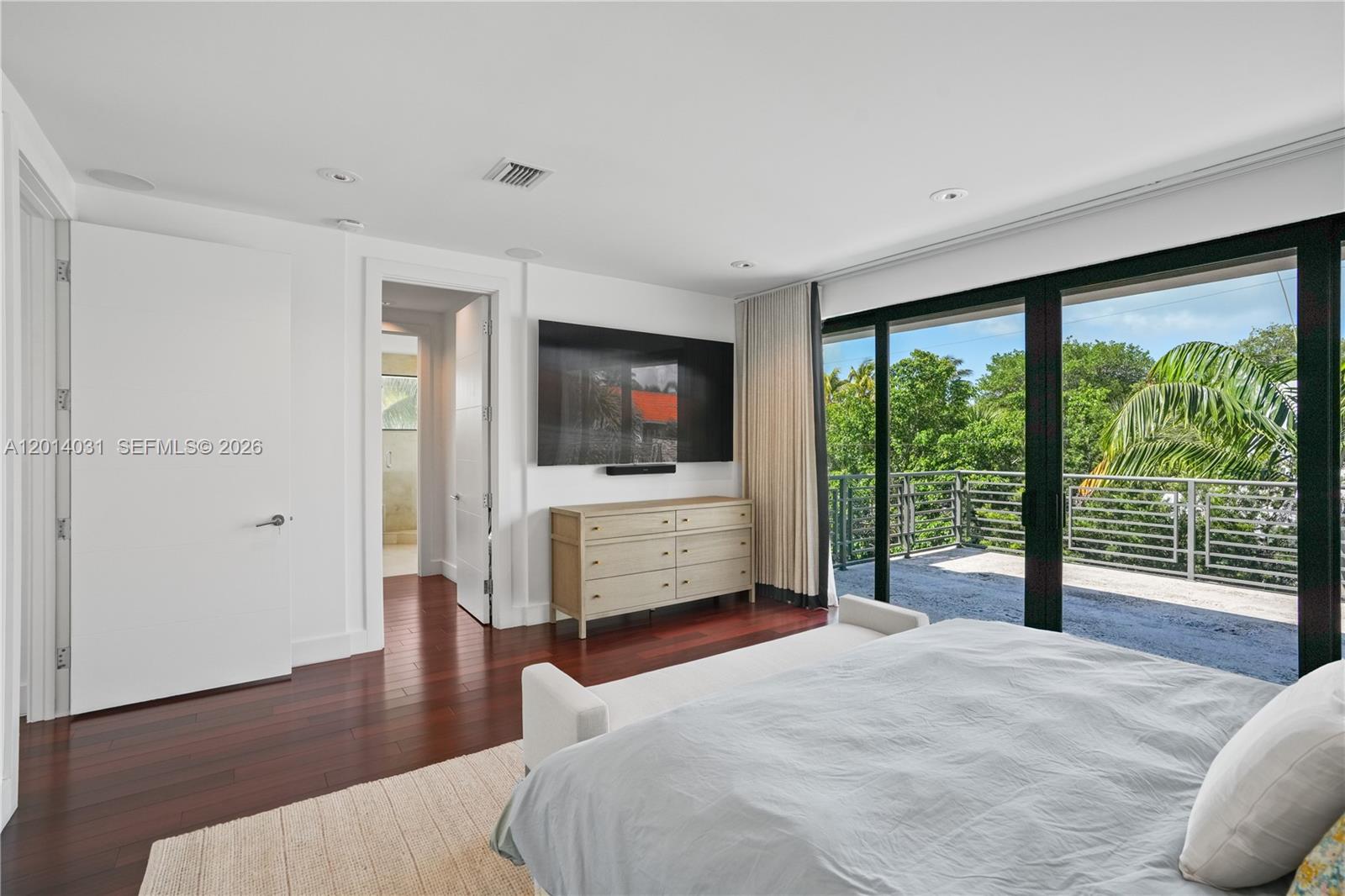 762 Fernwood Road Key Biscayne, FL 33149 - Photo 46 of 82 a bedroom with a bed and a flat screen tv