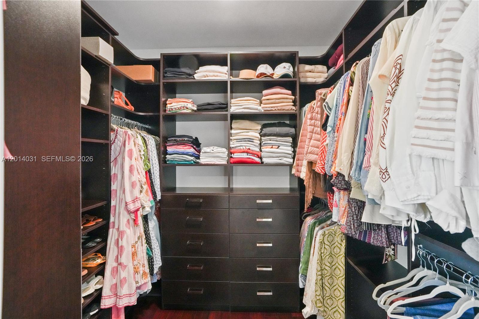 762 Fernwood Road Key Biscayne, FL 33149 - Photo 48 of 82 a view of walk in closet with clothes and shoes