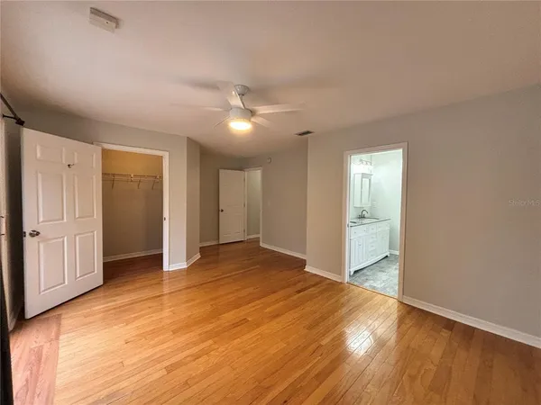 a view of empty room with wooden floor