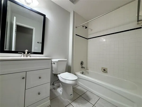 a bathroom with a toilet sink and a mirror
