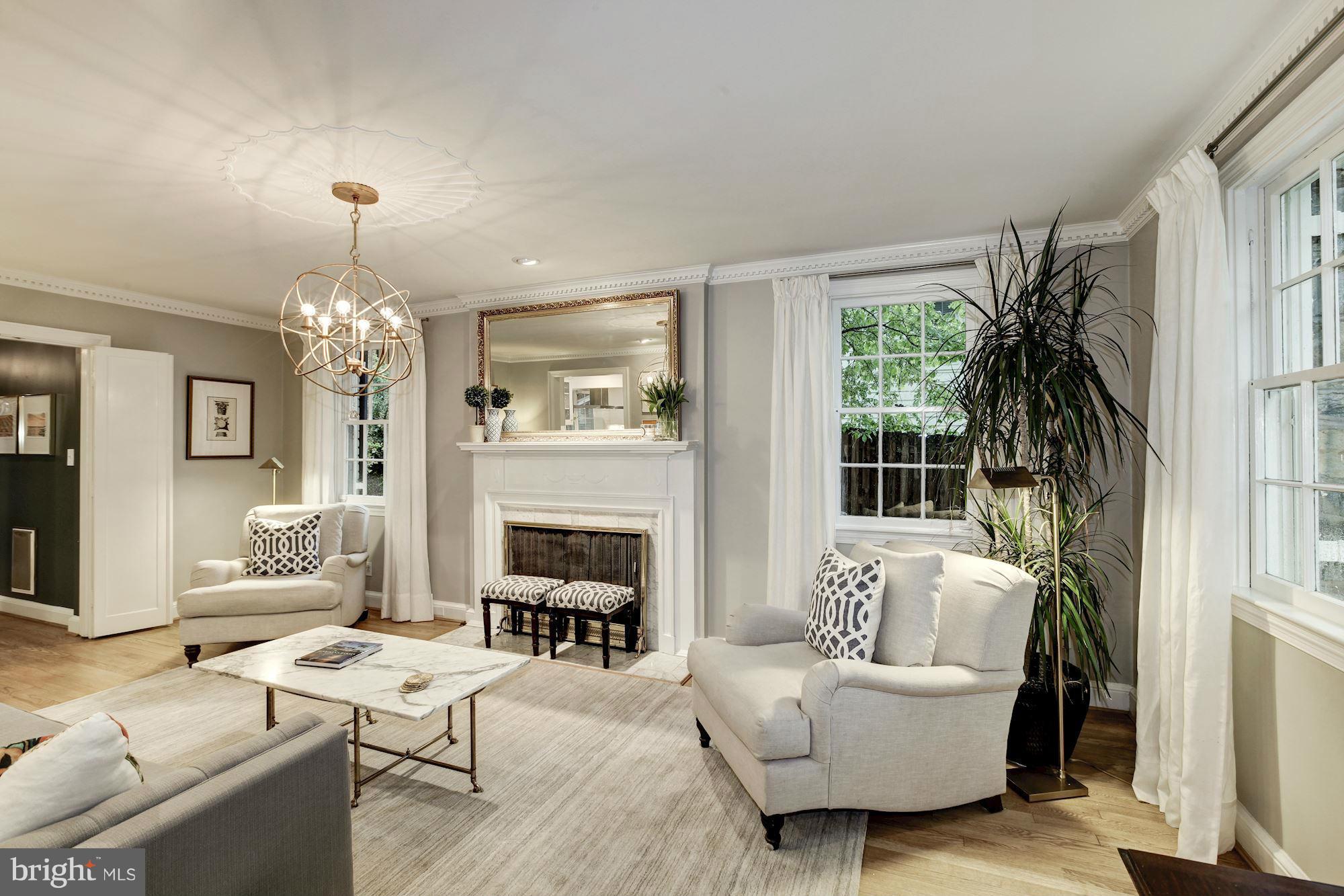 3055 Military Road Arlington, VA 22207 - Photo 2 of 30 a living room with furniture a chandelier and a fireplace