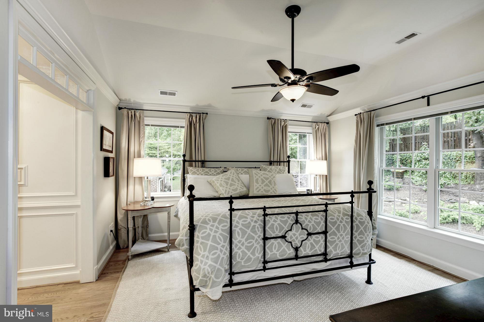 3055 Military Road Arlington, VA 22207 - Photo 14 of 30 a spacious bedroom with a bed a window and a chandelier