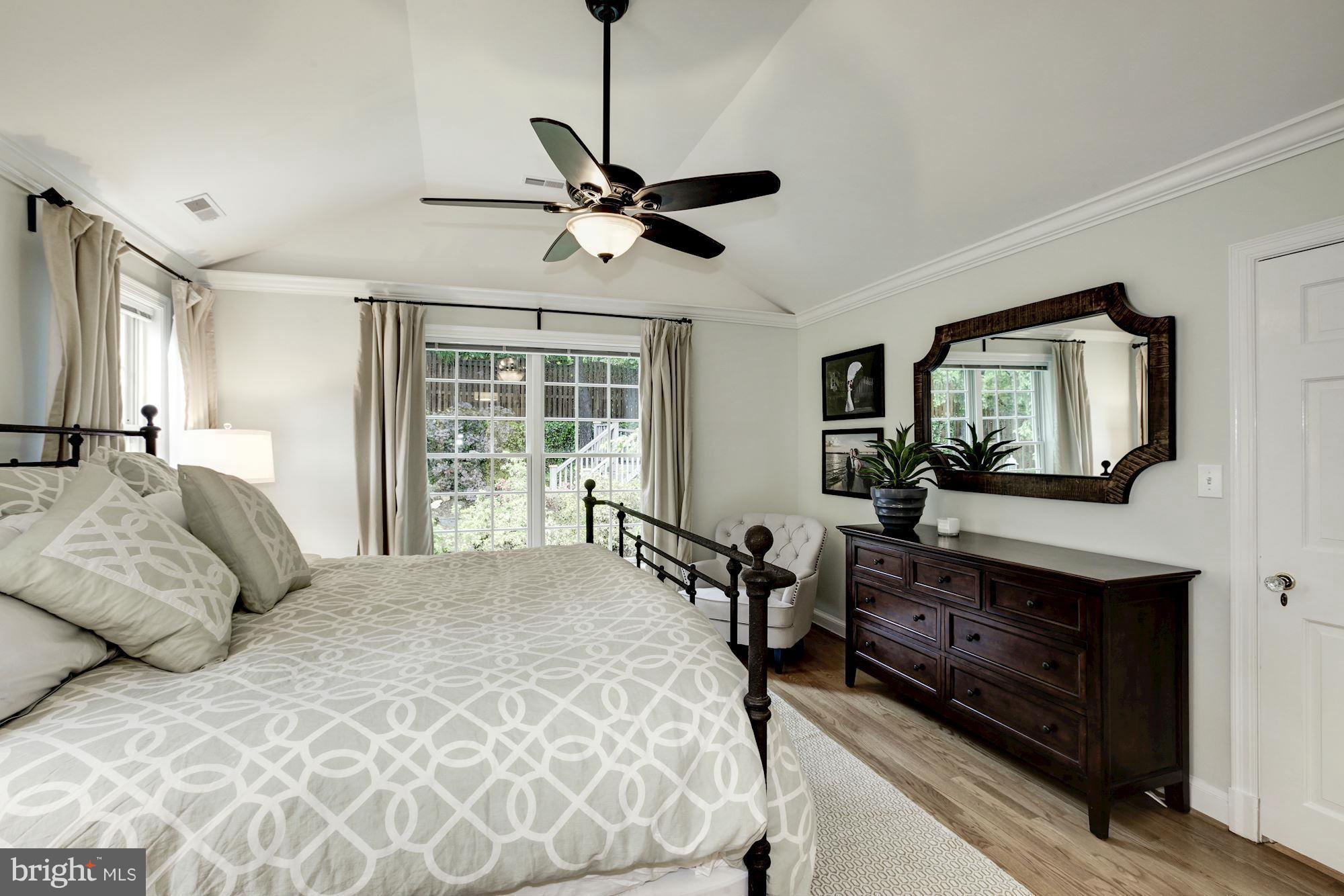 3055 Military Road Arlington, VA 22207 - Photo 15 of 30 a bedroom with a large bed and a chandelier