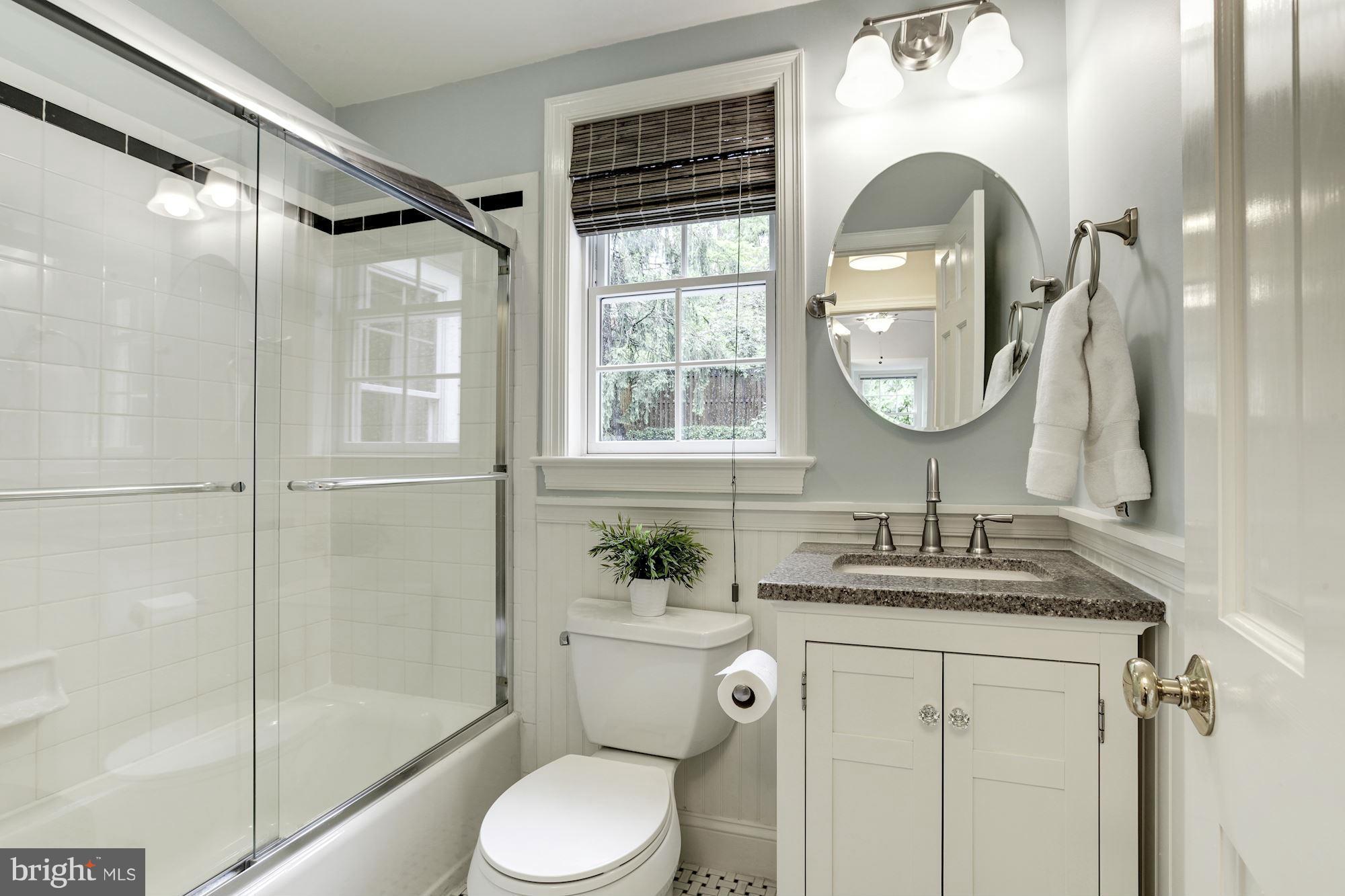 3055 Military Road Arlington, VA 22207 - Photo 21 of 30 a bathroom with a granite countertop sink toilet and shower