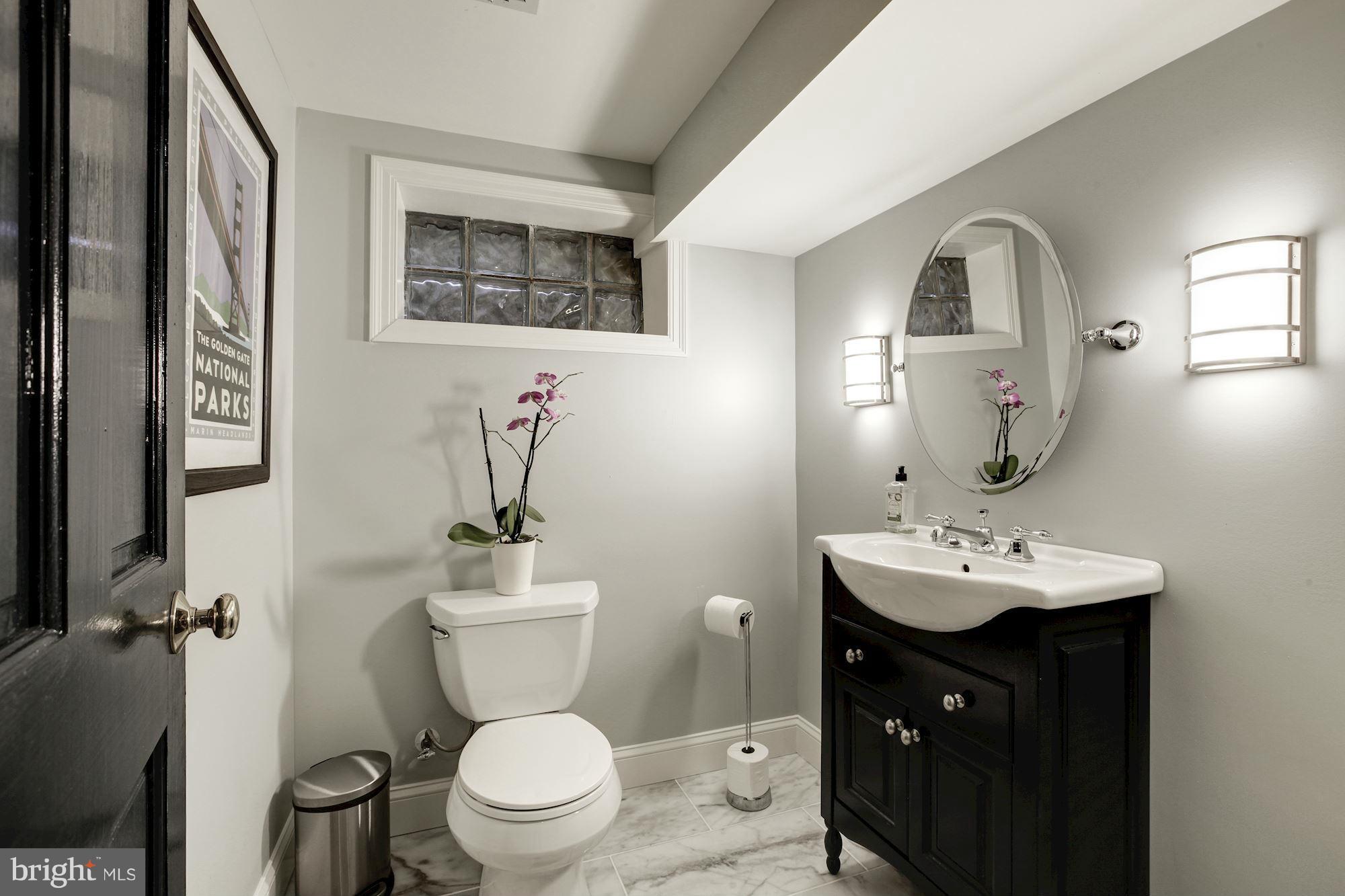 3055 Military Road Arlington, VA 22207 - Photo 26 of 30 a bathroom with a toilet sink and mirror