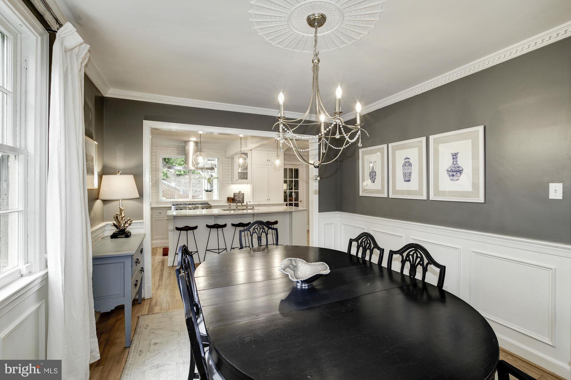 3055 Military Road Arlington, VA 22207 - Photo 5 of 30 a view of a dining room and livingroom with furniture wooden floor a chandelier