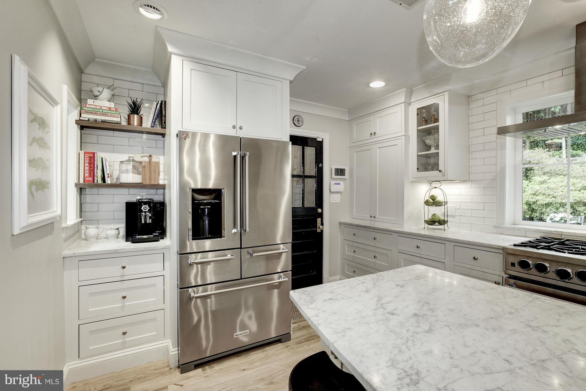 3055 Military Road Arlington, VA 22207 - Photo 10 of 30 a kitchen with white cabinets and stainless steel appliances