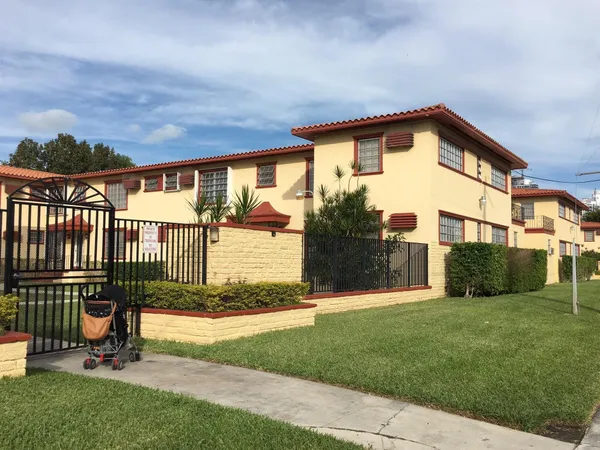 a view of a house with a yard and a garden