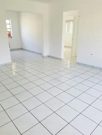 a view of an empty room and wooden floor