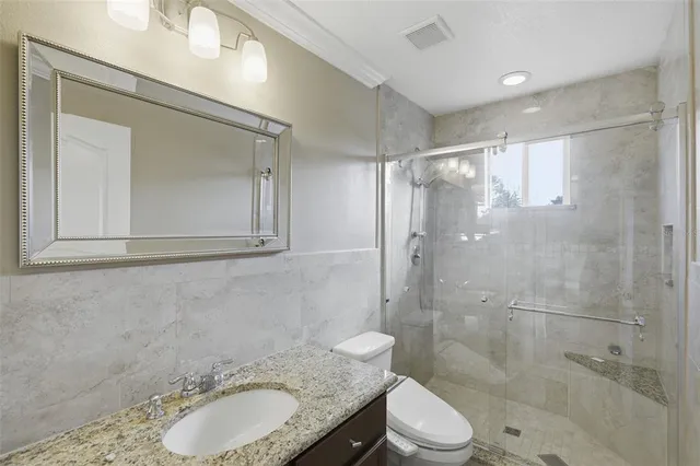 a bathroom that has a glass shower door