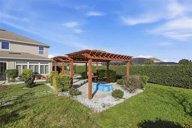 a view of a house with backyard porch and sitting area