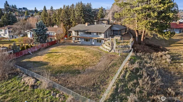 a view of a house with a yard and sitting area