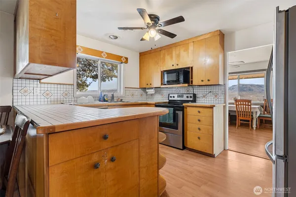 a kitchen with a stove a sink and a refrigerator