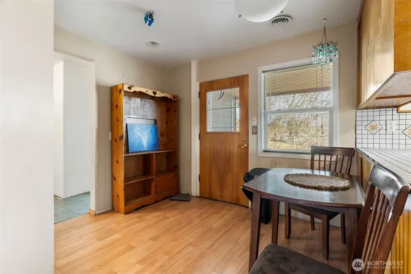 a view of a livingroom with furniture window and wooden floor