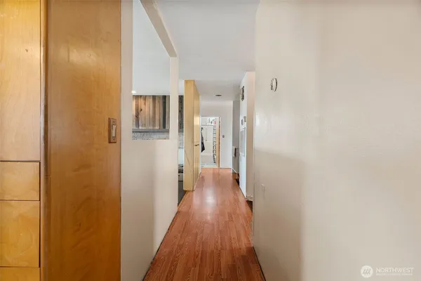 a view of a hallway with wooden floor