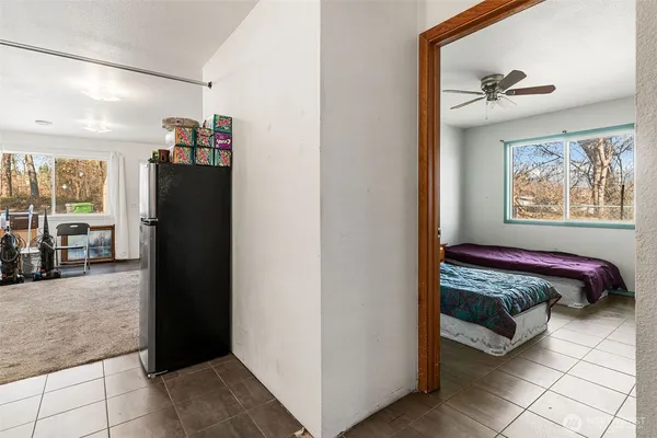 a bedroom with a bed and a painting on the wall