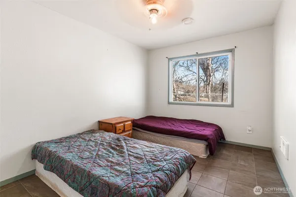 a bedroom with a bed and a painting on the wall