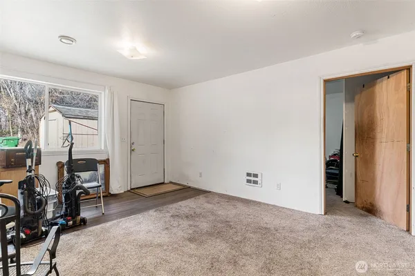 an empty room with table and chairs
