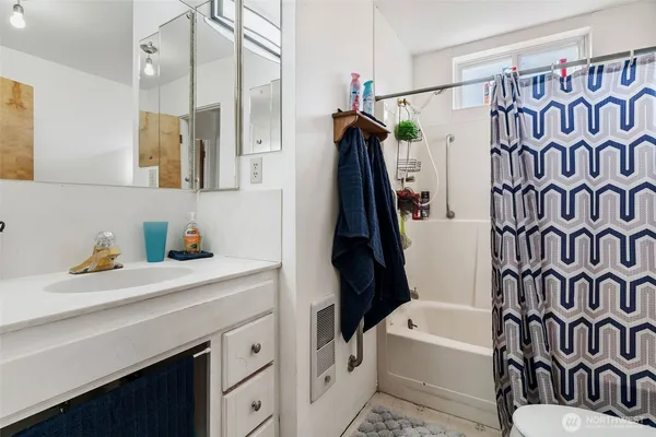 a bathroom with a sink a toilet and a bathtub
