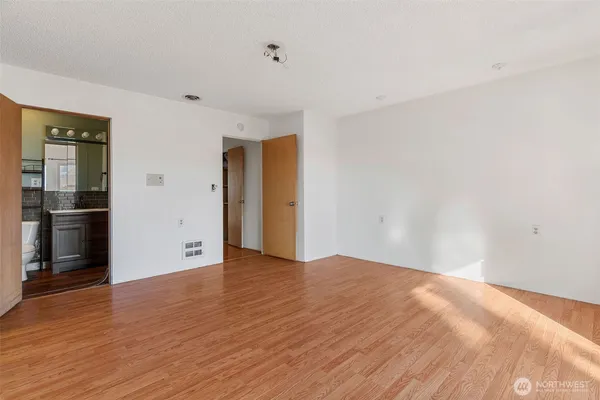 a view of an empty room with wooden floor