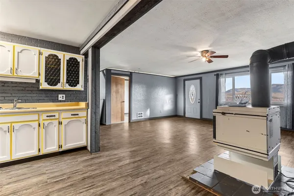 a view of a kitchen with a dishwasher cabinets and a wooden floor