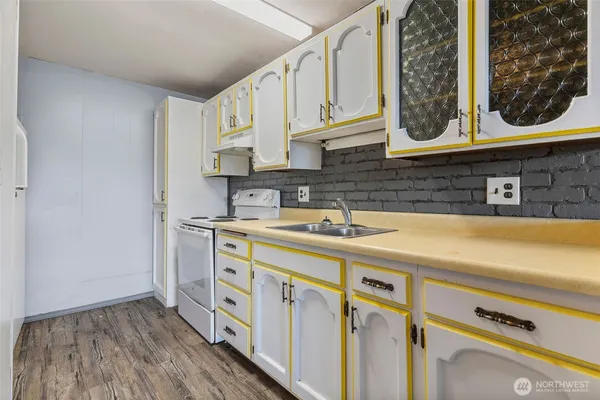 a kitchen with stainless steel appliances a sink and cabinets
