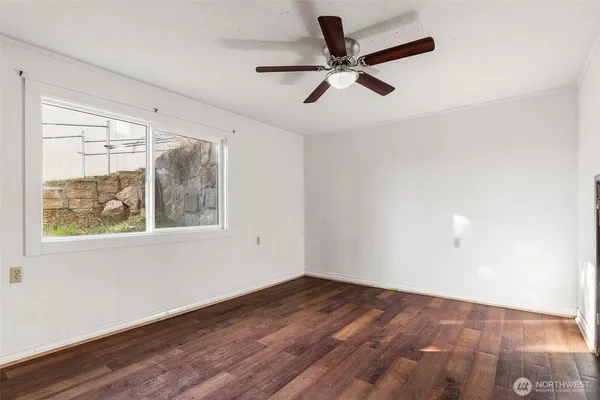 a view of a big room with wooden floor closet and windows