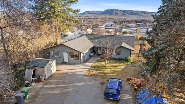 an aerial view of a house with a yard basket ball court and outdoor seating