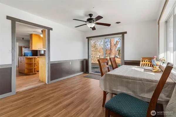 a view of a dining room with furniture window and wooden floor