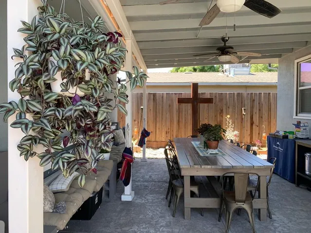a view of a patio with a table and chairs and couches