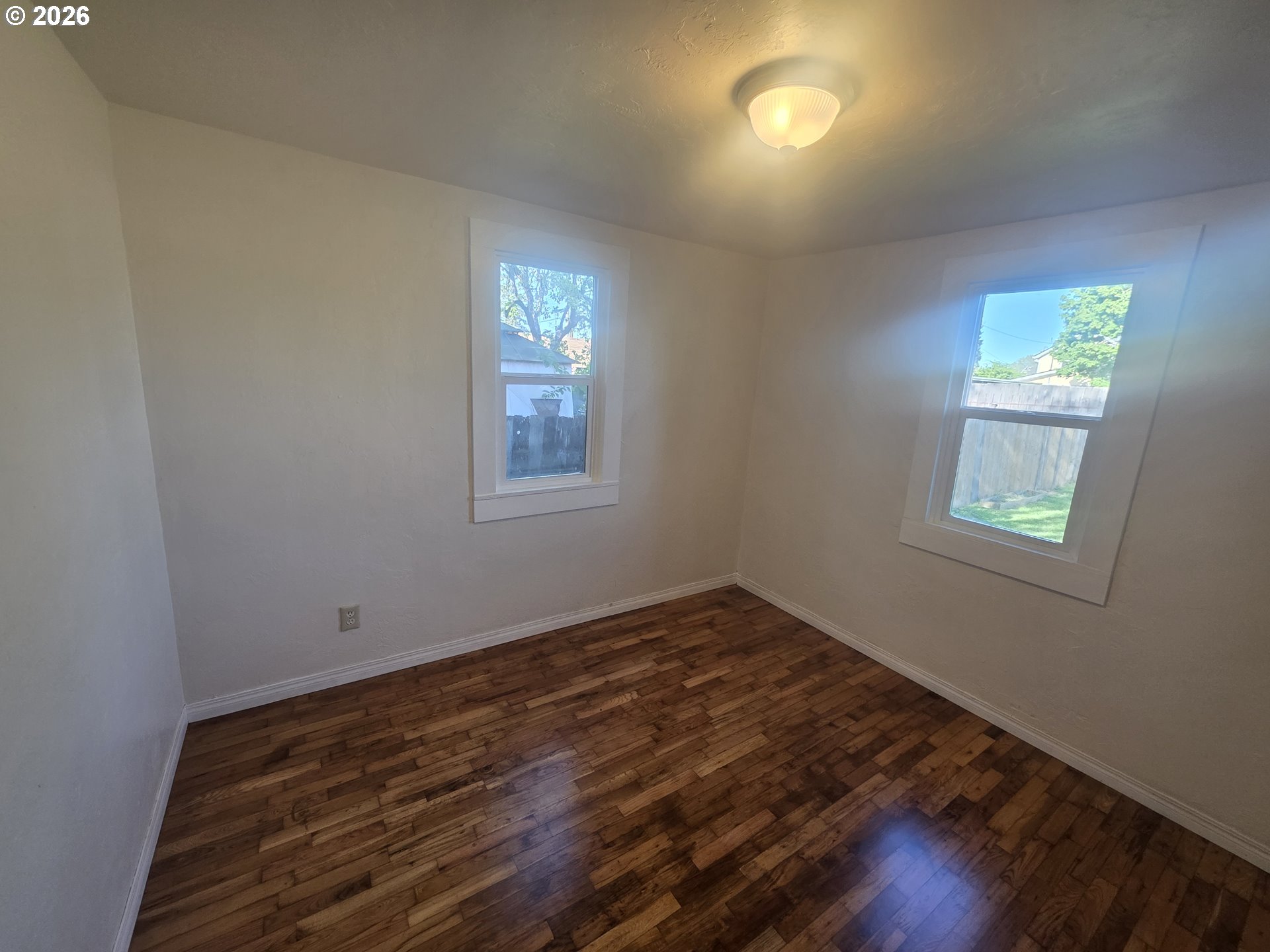 770 Elm Street Junction City, OR 97448 - Photo 16 of 30 a view of a room with wooden floor and windows